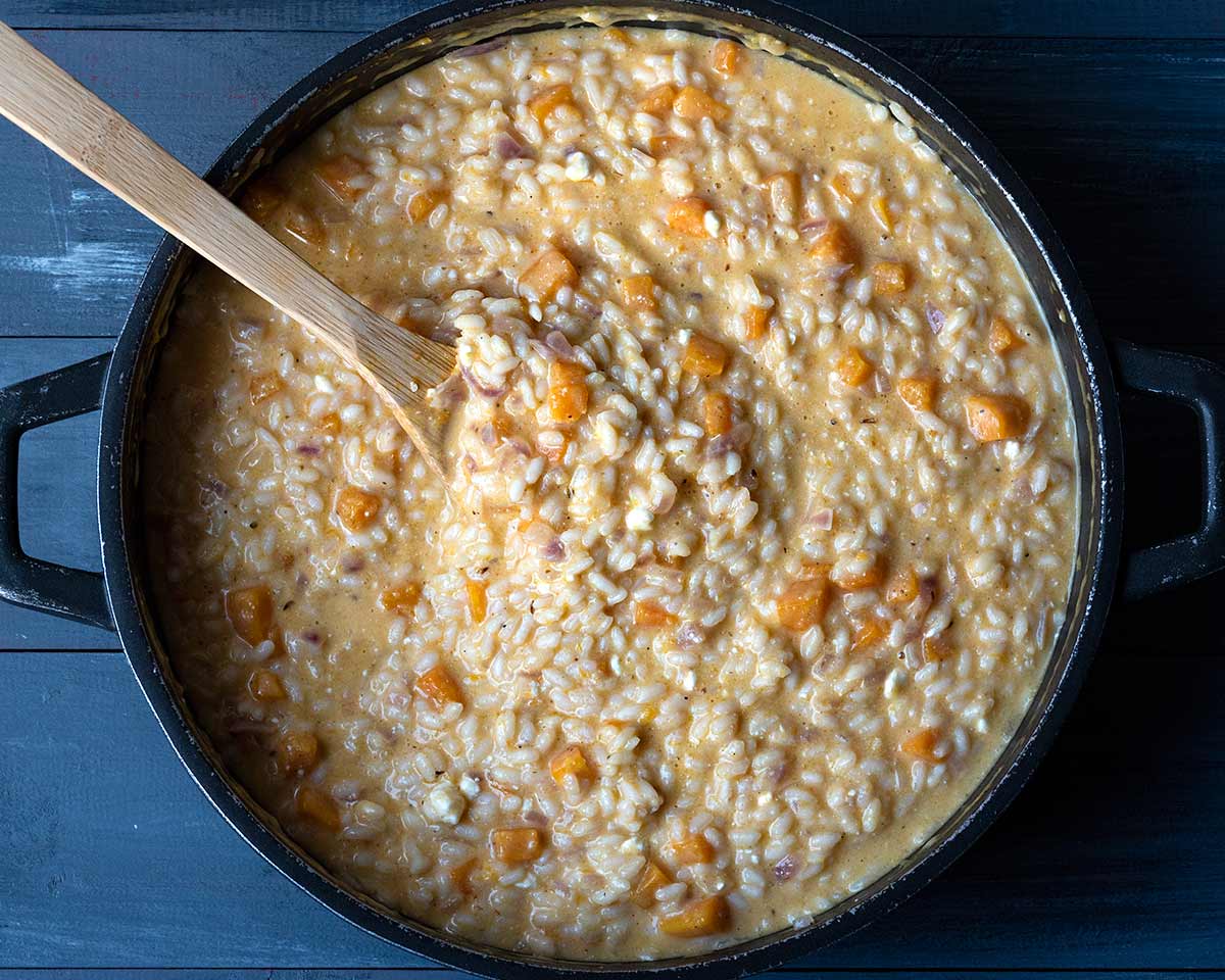 A large skillet with cooked pumpkin risotto.