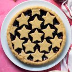 Italian crostata a.k.a. jam tart on a white plate.