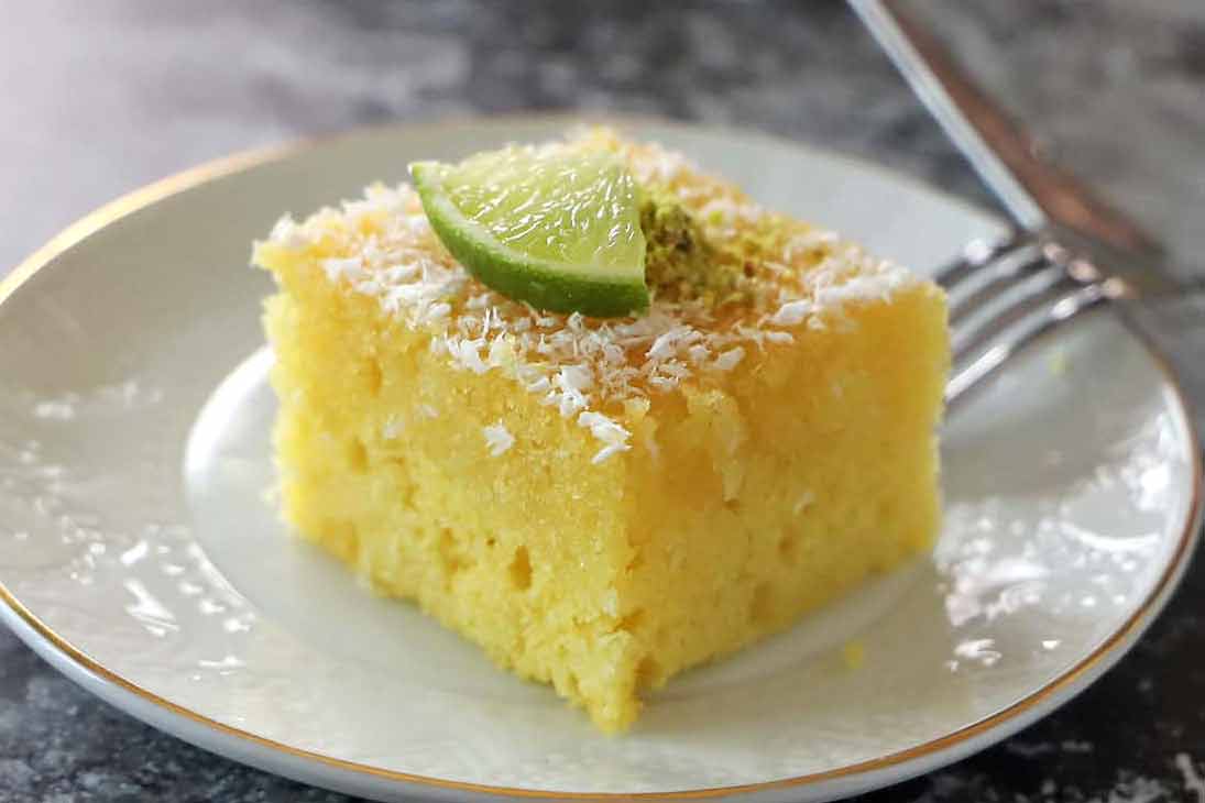 A slice of Greek Revani cake on a plate.