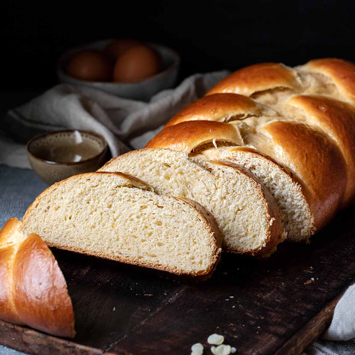 Greek Easter bread (Tsoureki) on a cutting board.