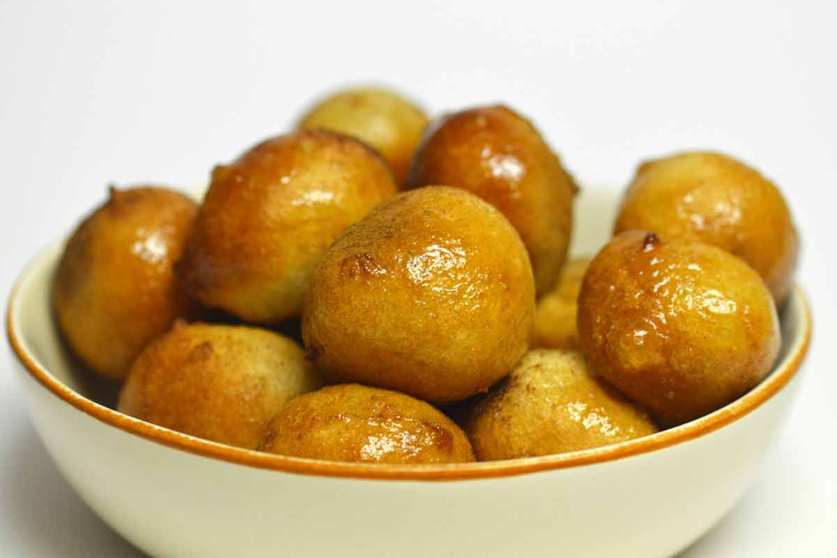 Loukoumades with honey inside a bowl.