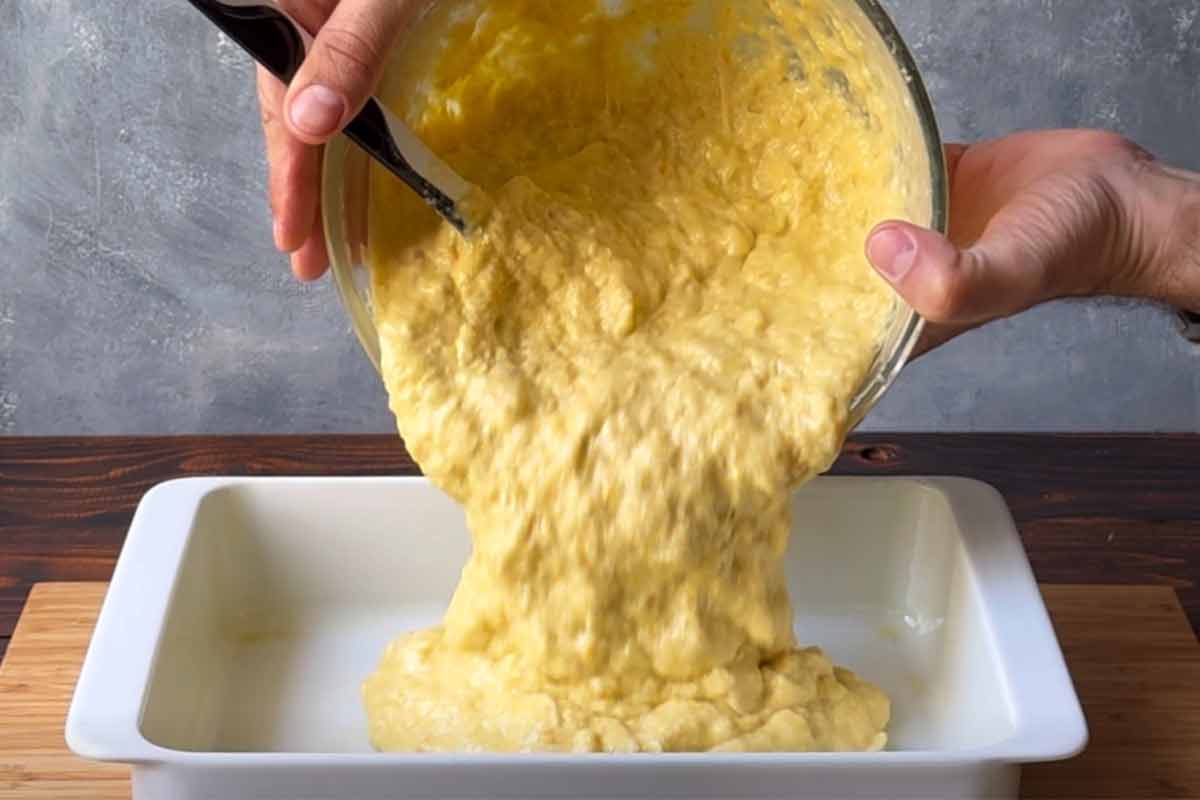 Pouring the cake batter into the baking dish.