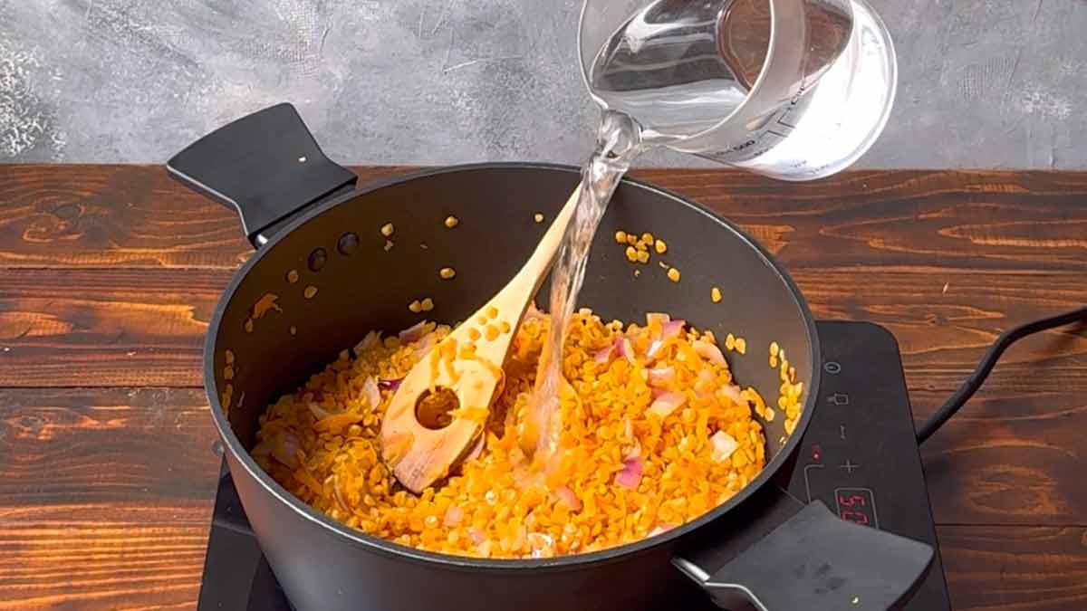Adding water to the pot.