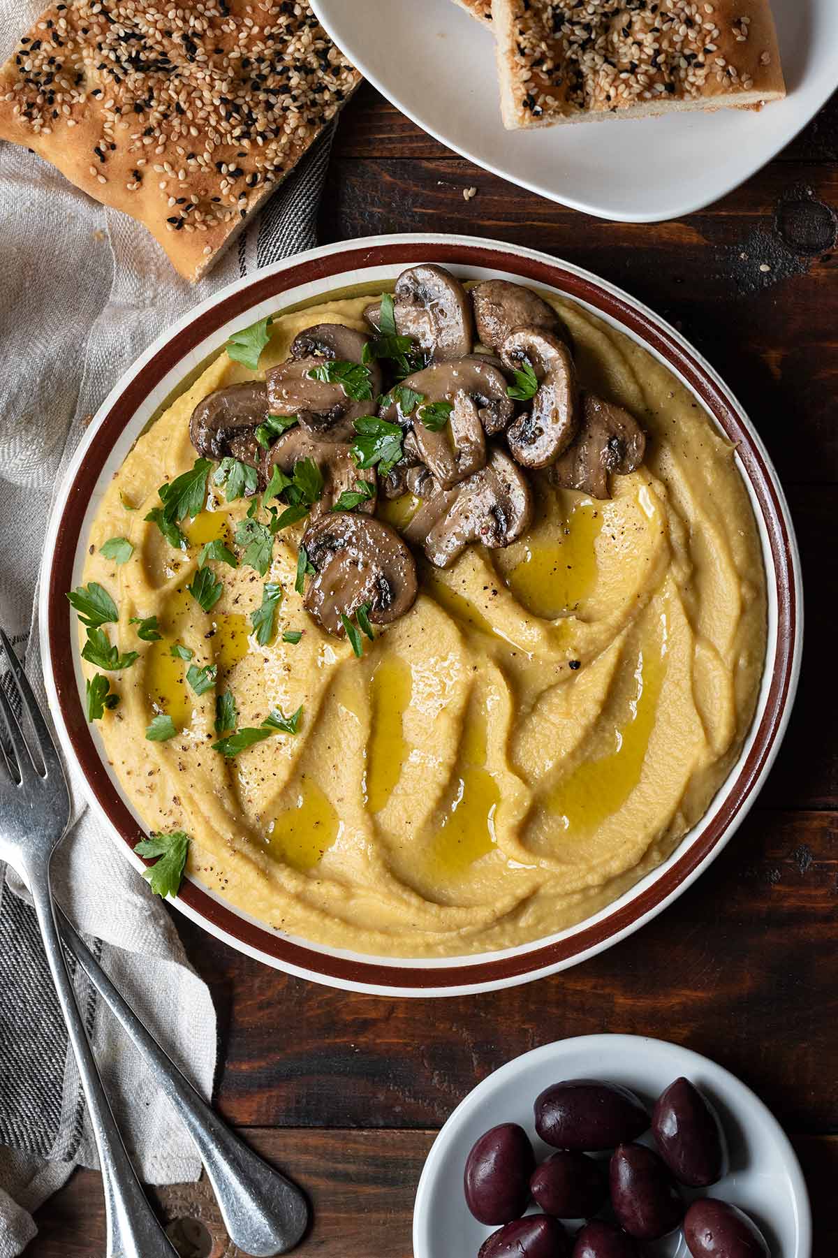 A plate with Greek fava (yellow split pea puree) and sauteed mushrooms.