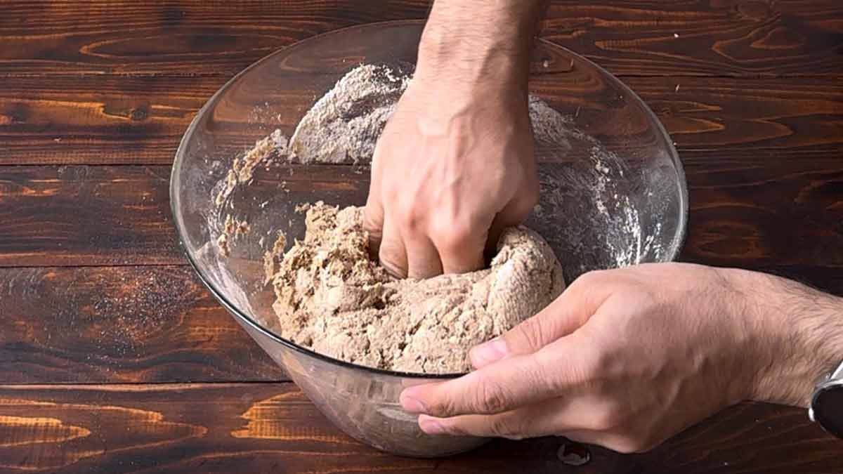 A hand kneading the dough.