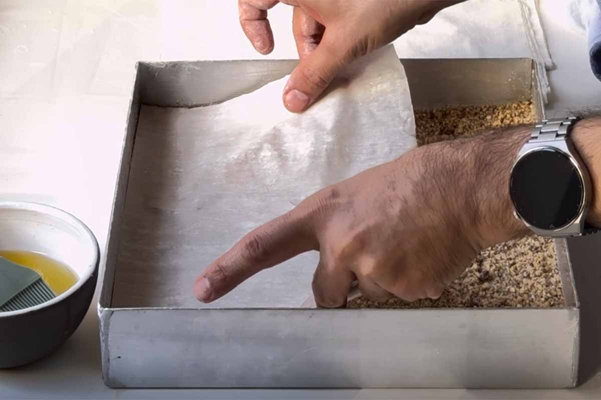 Adding the top layer of phyllo sheets.