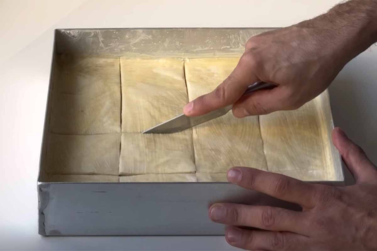 Cutting the baklava before baking.