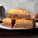 A plate with 3 baklava pieces.
