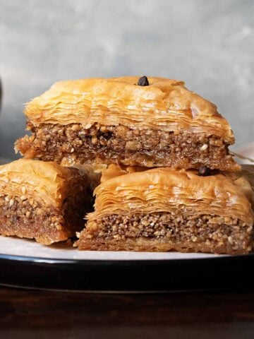 A plate with 3 baklava pieces.