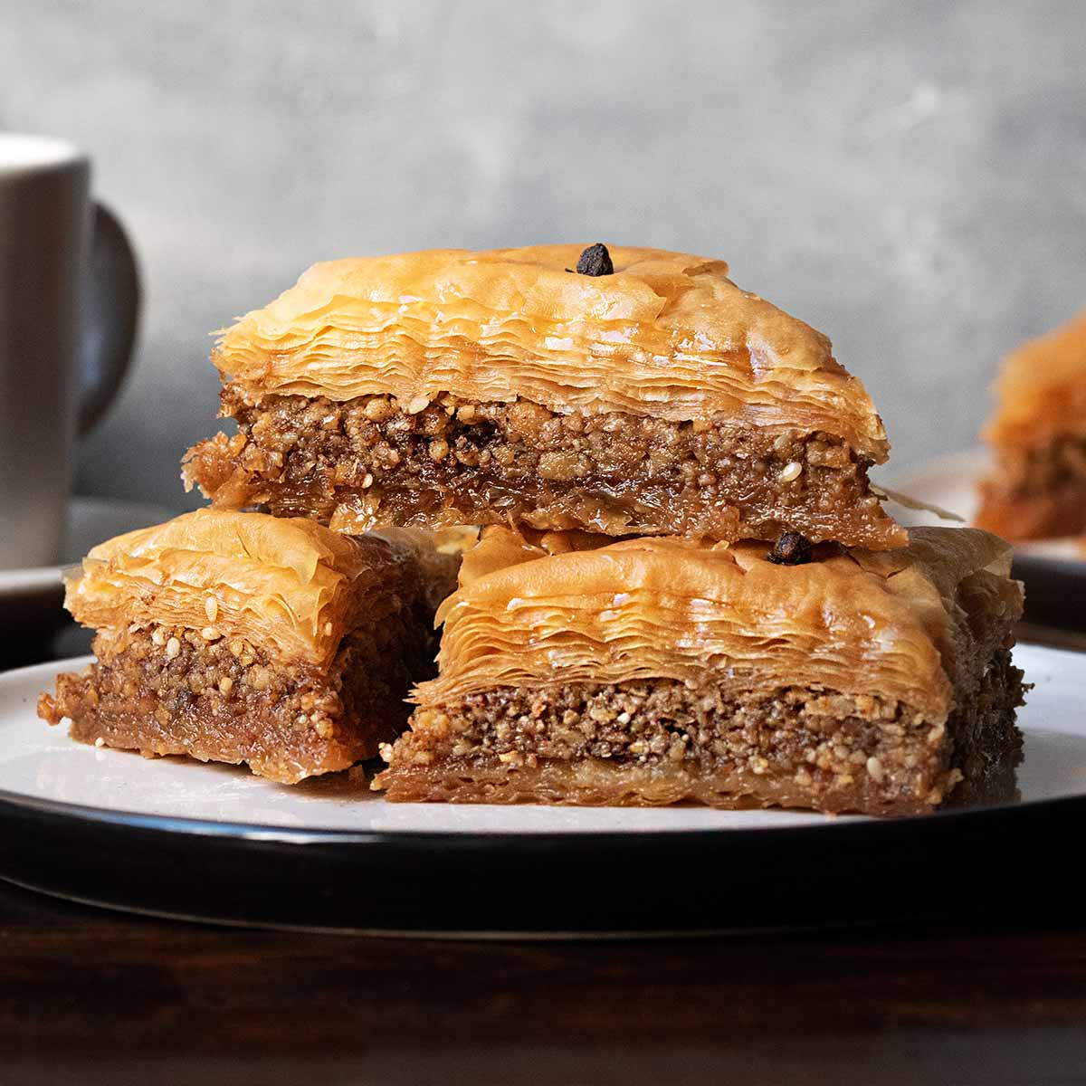 A plate with 3 baklava pieces.