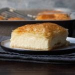 A slice of Greek galaktoboureko with crispy phyllo and custard cream.