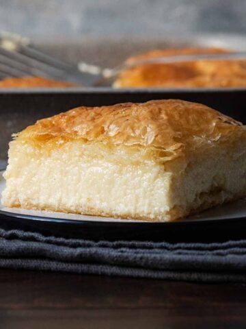 A slice of Greek galaktoboureko with crispy phyllo and custard cream.