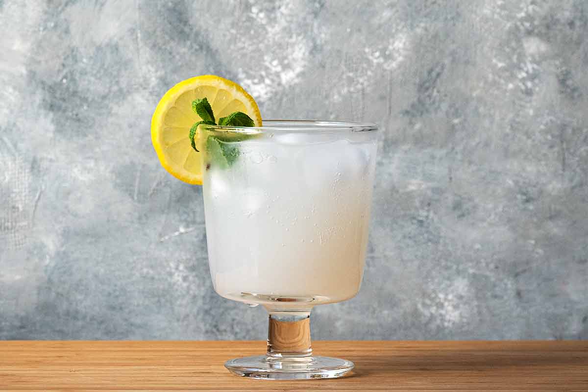 A glass with ouzo and lemonade.