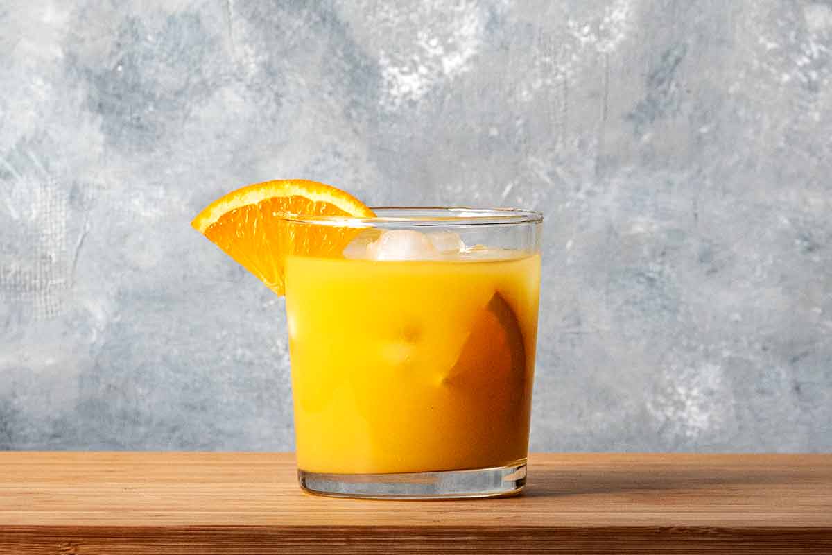 A glass with ouzo and orange juice.