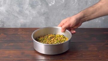 Pistachio nuts in a baking pan.