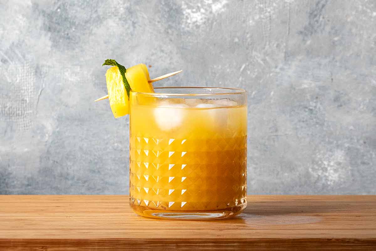 A glass with ouzo, pineapple juice and orange juice.