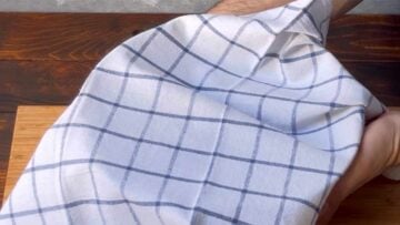 Two hands covering the bowl with a towel.