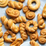 Koulourakia cookies on parchment paper.