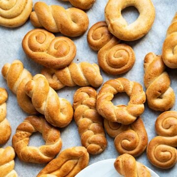 Koulourakia cookies on parchment paper.