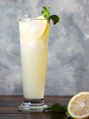 A glass with ouzo lemon drink.