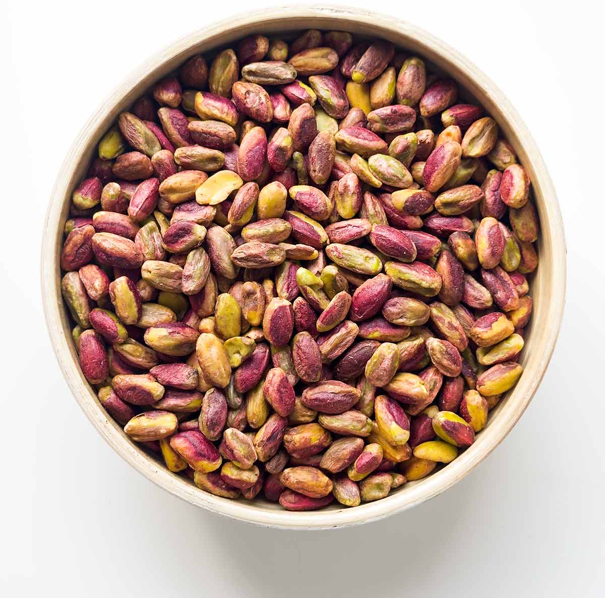 A bowl with pistachio nuts.