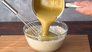 Adding white chocolate and pistachio butter to the bowl.