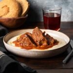 Kokkinisto - Greek beef stew on a plate with mashed potatoes.