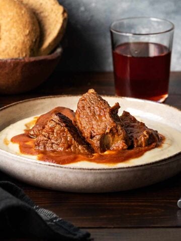Kokkinisto - Greek beef stew on a plate with mashed potatoes.