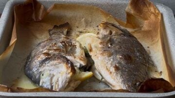 Broiled sea bream in a baking pan.