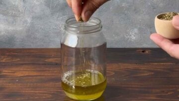 Adding oregano th the ladolemono.