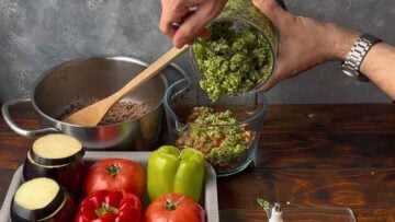 Processed vegetables transfered to the bowl of a food chopper.