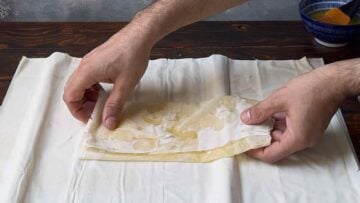 Folded filo pastry on a working surface.