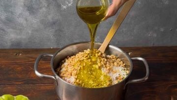 Rice and other ingredients in a pot with ground meat.