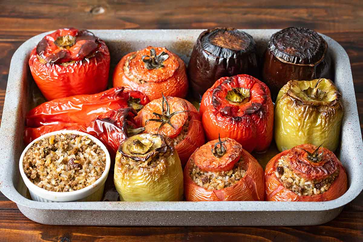 Greek stuffed vegetables with rice and meat in a baking dish.