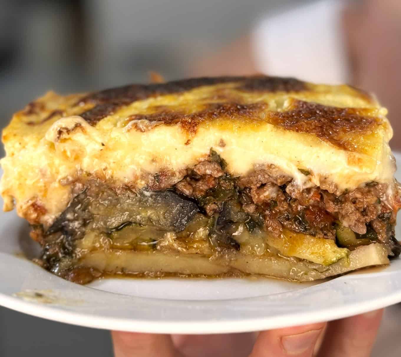 A piece of Moussaka on a plate.