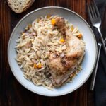 Greek lemon chicken and orzo on a plate.