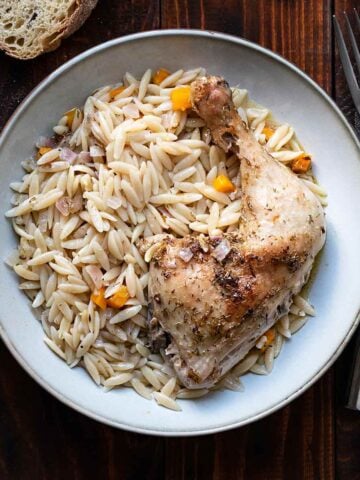 Greek lemon chicken and orzo on a plate.