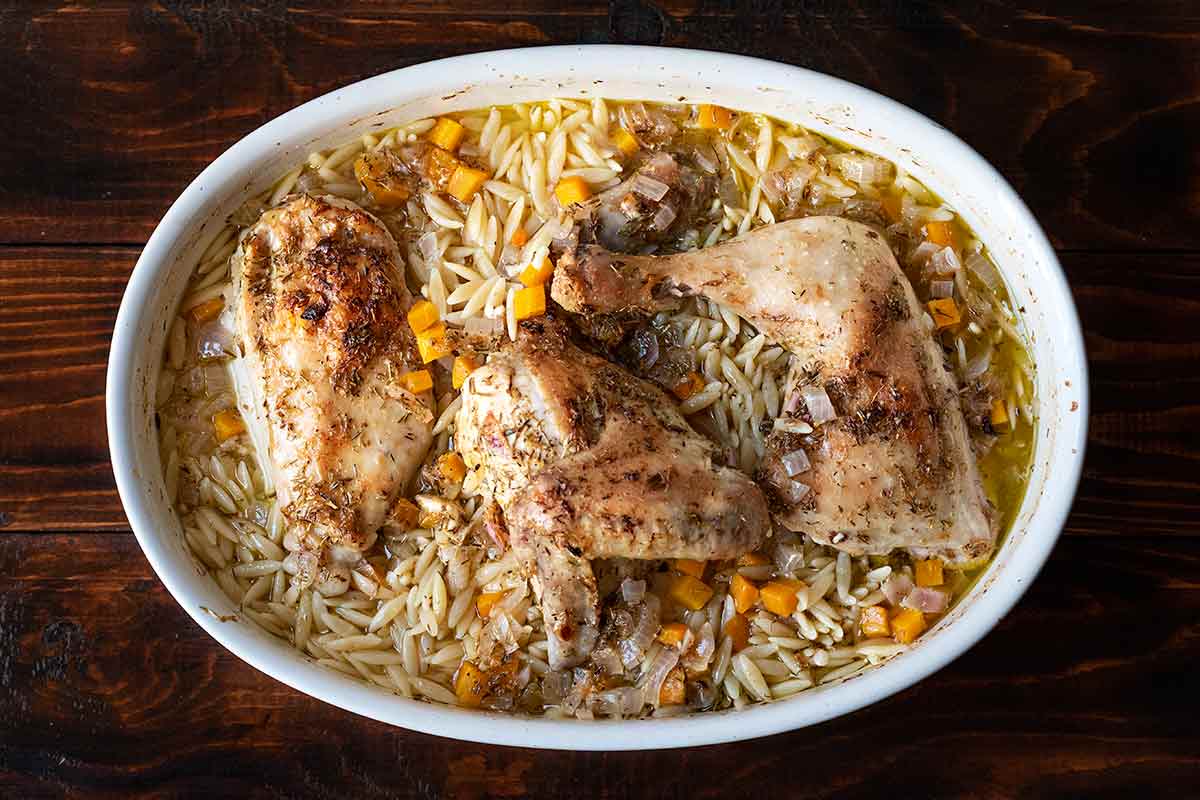 Greek lemon chicken orzo in a baking dish.