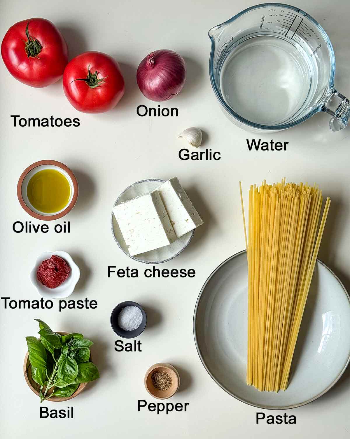 Ingredients for tomato pasta with text overlay.