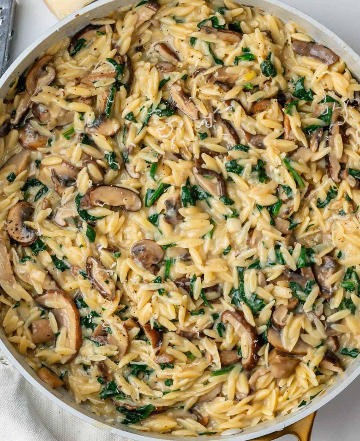 Mushroom orzo in a skillet.