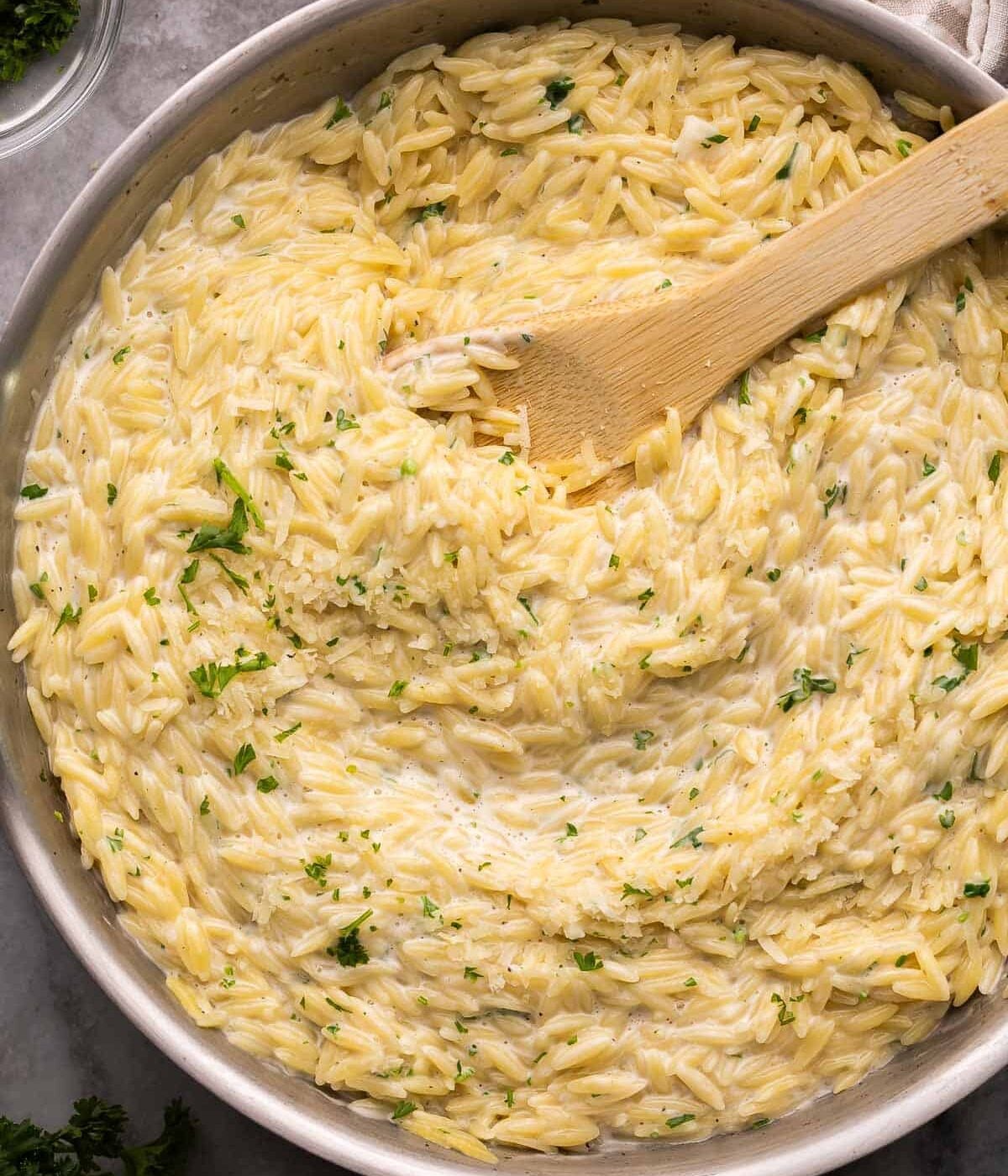 Garlic and parmesan orzo pasta in a pan.