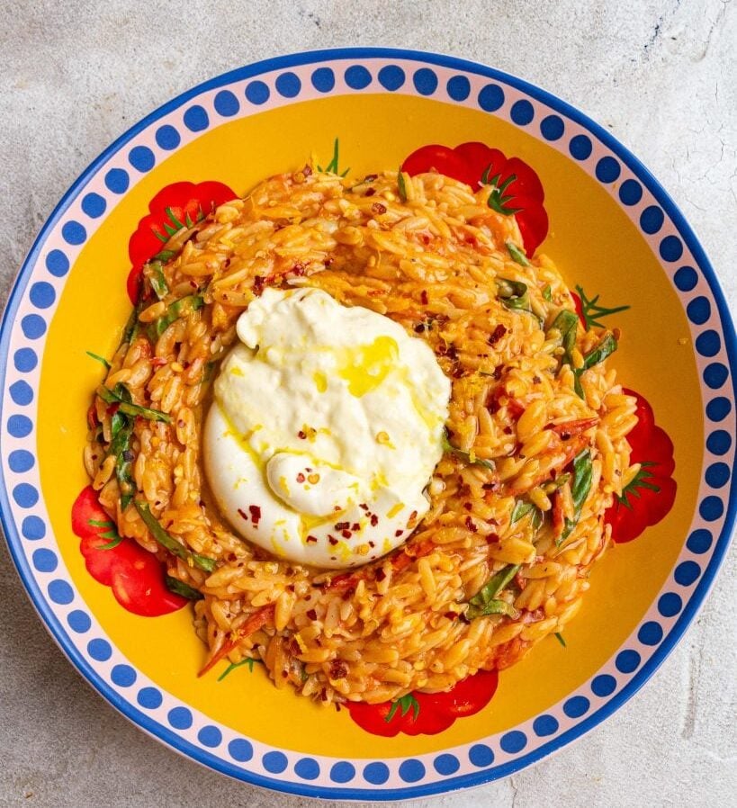 Orzo with burata on a plate.