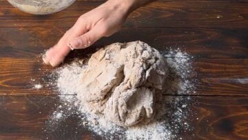 A hand kneading a dough.