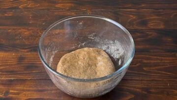 A cinnamon bun dough in a bowl.