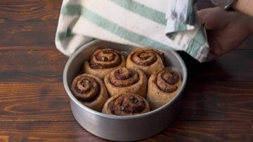 Cinnamon buns before baking in a pan.