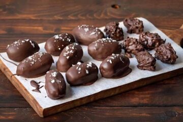 Chocolate covered dates on a serving board.