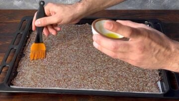 Brushing the dough with olive oil.