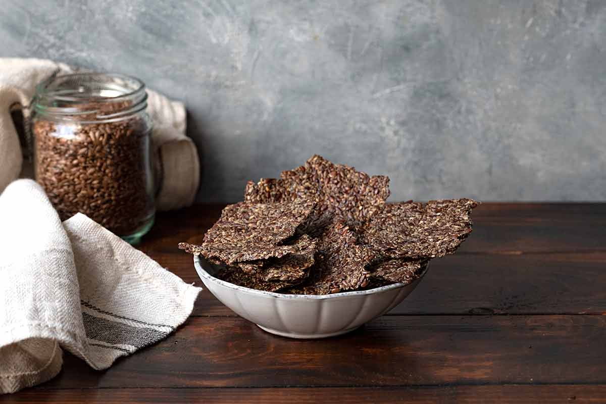 A small bowl with flaxseed crackers.