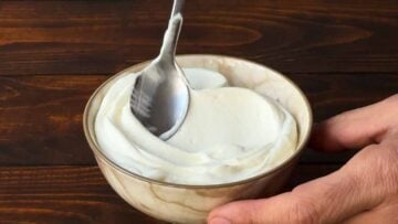 A bowl with Greek yogurt and a spoon.