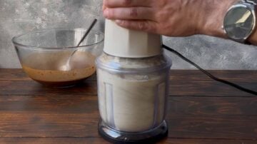 A food chopper with dry milk in it.